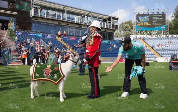 110819 - Glamorgan v Surrey, Vitality Blast - Imran Tahir of Surrey meets Shenkin the mascot of the 3rd Battalion The Royal Welsh Regiment as he prepares to lead the teams out at the start of the match