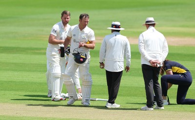 190626 - Glamorgan v Surrey, Rothesay County Championship Division 1- Colin Ingram of Glamorgan receives treatment to a hand injury before being forced to retire Not Out