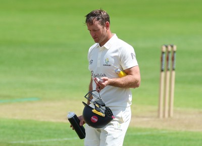 190626 - Glamorgan v Surrey, Rothesay County Championship Division 1- Colin Ingram of Glamorgan receives treatment to a hand injury before being forced to retire Not Out