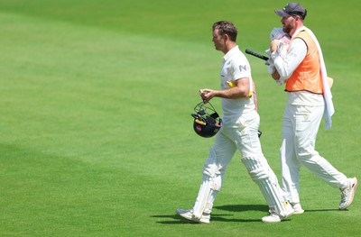 190626 - Glamorgan v Surrey, Rothesay County Championship Division 1- Colin Ingram of Glamorgan receives treatment to a hand injury before being forced to retire Not Out