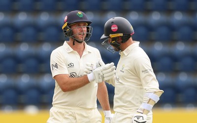 190626 - Glamorgan v Surrey, Rothesay County Championship Division 1- Chris Cooke of Glamorgan and Mason Crane of Glamorgan celebrate their 100 partnership