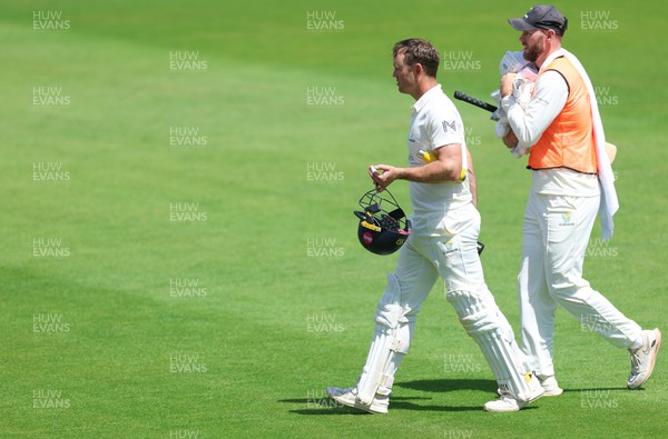 190626 - Glamorgan v Surrey, Rothesay County Championship Division 1- Colin Ingram of Glamorgan receives treatment to a hand injury before being forced to retire Not Out
