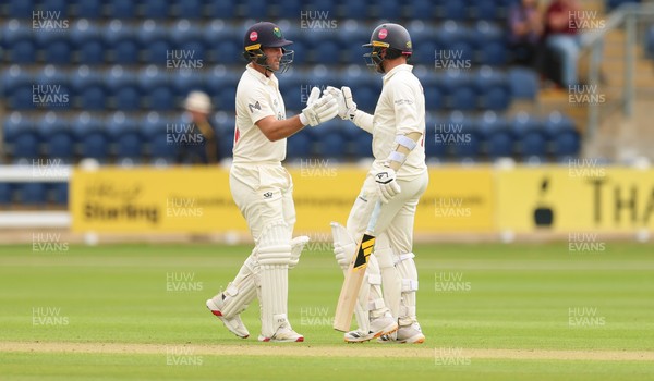 190626 - Glamorgan v Surrey, Rothesay County Championship Division 1- Chris Cooke of Glamorgan and Mason Crane of Glamorgan celebrate their 100 partnership