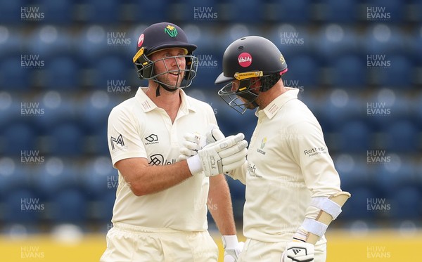 190626 - Glamorgan v Surrey, Rothesay County Championship Division 1- Chris Cooke of Glamorgan and Mason Crane of Glamorgan celebrate their 100 partnership