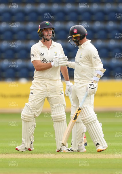 190626 - Glamorgan v Surrey, Rothesay County Championship Division 1- Chris Cooke of Glamorgan and Mason Crane of Glamorgan celebrate their 100 partnership