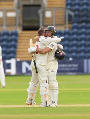 200626 - Glamorgan v Surrey, Rothesay County Championship Division 1- Mason Crane of Glamorgan celebrates with Colin Ingram of Glamorgan as he reaches his 100