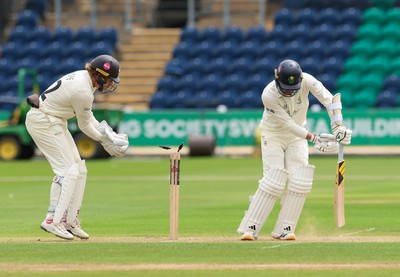 200626 - Glamorgan v Surrey, Rothesay County Championship Division 1- Mason Crane of Glamorgan is bowled by Dan Lawrence of Surrey for 106