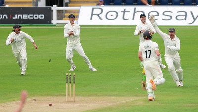 200626 - Glamorgan v Surrey, Rothesay County Championship Division 1- Glamorgan celebrate as Rory Burns of Surrey is run out by Ben Kellaway of Glamorgan