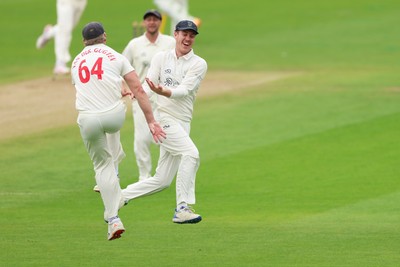 200626 - Glamorgan v Surrey, Rothesay County Championship Division 1- Ben Kellaway of Glamorgan celebrates with Timm van der Gugten of Glamorgan after he runs out Rory Burns of Surrey