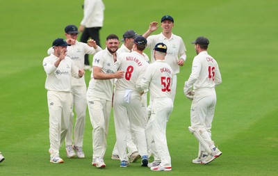 200626 - Glamorgan v Surrey, Rothesay County Championship Division 1- Ben Kellaway of Glamorgan celebrates with team mates after he runs out Rory Burns of Surrey