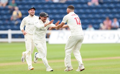 200626 - Glamorgan v Surrey, Rothesay County Championship Division 1- Tom Norton  of Glamorgan celebrates with Kiran Carlson of Glamorgan after taking the wicket of Dom Sibley of Surrey