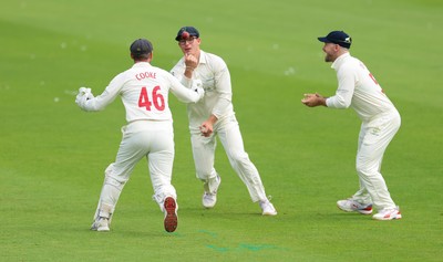 200626 - Glamorgan v Surrey, Rothesay County Championship Division 1- Asa Tribe of Glamorgan celebrates with Chris Cooke of Glamorgan as he catches Gus Atkinson of Surrey