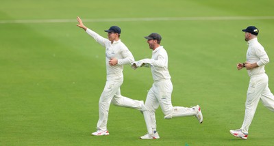 200626 - Glamorgan v Surrey, Rothesay County Championship Division 1- Asa Tribe of Glamorgan celebrates with Chris Cooke of Glamorgan as he catches Gus Atkinson of Surrey