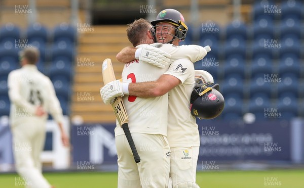 200626 - Glamorgan v Surrey, Rothesay County Championship Division 1- Mason Crane of Glamorgan celebrates with Colin Ingram of Glamorgan as he reaches his 100