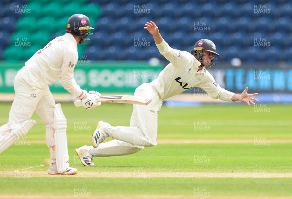 200626 - Glamorgan v Surrey, Rothesay County Championship Division 1- Adam Thomas of Surrey looks to catch Mason Crane of Glamorgan