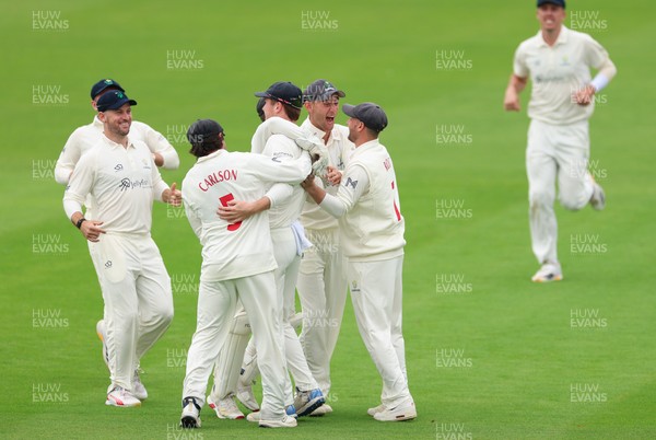 200626 - Glamorgan v Surrey, Rothesay County Championship Division 1- Ben Kellaway of Glamorgan celebrates with team mates after he runs out Rory Burns of Surrey
