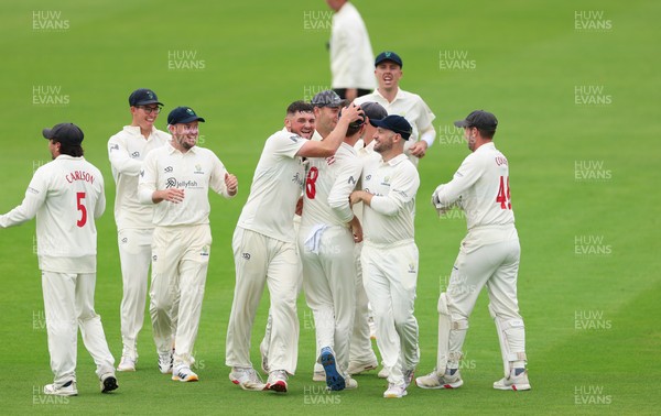 200626 - Glamorgan v Surrey, Rothesay County Championship Division 1- Ben Kellaway of Glamorgan celebrates with team mates after he runs out Rory Burns of Surrey