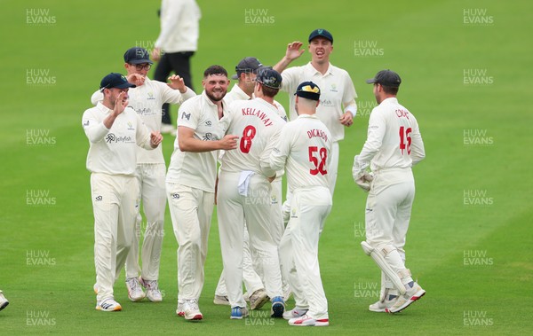 200626 - Glamorgan v Surrey, Rothesay County Championship Division 1- Ben Kellaway of Glamorgan celebrates with team mates after he runs out Rory Burns of Surrey