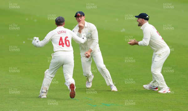 200626 - Glamorgan v Surrey, Rothesay County Championship Division 1- Asa Tribe of Glamorgan celebrates with Chris Cooke of Glamorgan as he catches Gus Atkinson of Surrey