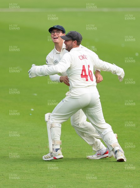 200626 - Glamorgan v Surrey, Rothesay County Championship Division 1- Asa Tribe of Glamorgan celebrates with Chris Cooke of Glamorgan as he catches Gus Atkinson of Surrey