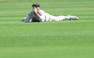 210626 - Glamorgan v Surrey, Rothesay County Championship Division 1- Ben Kellaway of Glamorgan reacts after he fails to take an opportunity to catch Rory Burns of Surrey