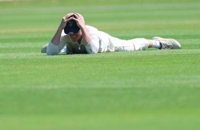 210626 - Glamorgan v Surrey, Rothesay County Championship Division 1- Ben Kellaway of Glamorgan reacts after he fails to take an opportunity to catch Rory Burns of Surrey