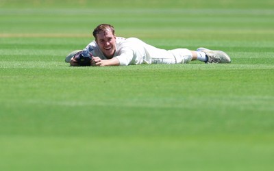 210626 - Glamorgan v Surrey, Rothesay County Championship Division 1- Ben Kellaway of Glamorgan reacts after he fails to take an opportunity to catch Rory Burns of Surrey