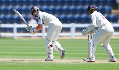 210626 - Glamorgan v Surrey, Rothesay County Championship Division 1- Ollie Pope of Surrey plays a shot past Chris Cooke of Glamorgan