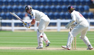 210626 - Glamorgan v Surrey, Rothesay County Championship Division 1- Ollie Pope of Surrey plays a shot past Chris Cooke of Glamorgan