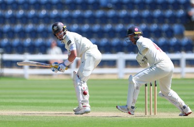 210626 - Glamorgan v Surrey, Rothesay County Championship Division 1- Ollie Pope of Surrey plays a shot past Chris Cooke of Glamorgan