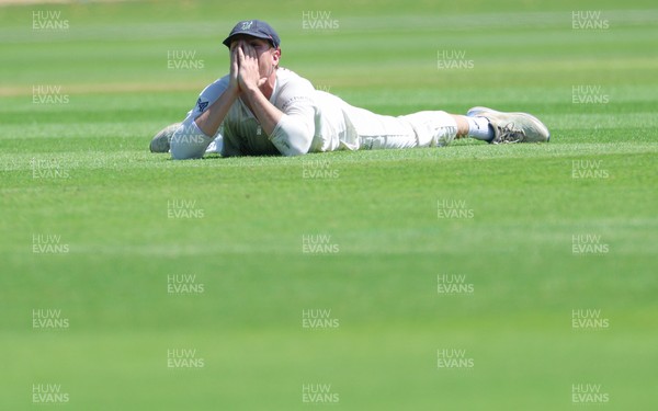 210626 - Glamorgan v Surrey, Rothesay County Championship Division 1- Ben Kellaway of Glamorgan reacts after he fails to take an opportunity to catch Rory Burns of Surrey