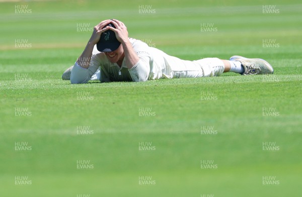 210626 - Glamorgan v Surrey, Rothesay County Championship Division 1- Ben Kellaway of Glamorgan reacts after he fails to take an opportunity to catch Rory Burns of Surrey