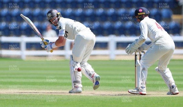 210626 - Glamorgan v Surrey, Rothesay County Championship Division 1- Ollie Pope of Surrey plays a shot past Chris Cooke of Glamorgan