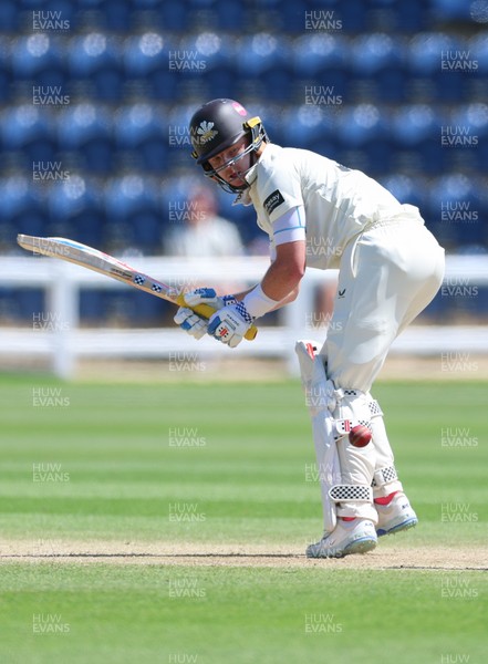 210626 - Glamorgan v Surrey, Rothesay County Championship Division 1- Ollie Pope of Surrey plays a shot past Chris Cooke of Glamorgan