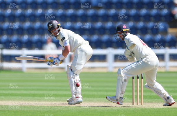 210626 - Glamorgan v Surrey, Rothesay County Championship Division 1- Ollie Pope of Surrey plays a shot past Chris Cooke of Glamorgan