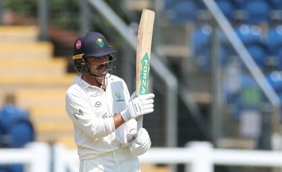 220626 - Glamorgan v Surrey, Rothesay County Championship Division 1- Kiran Carlson of Glamorgan celebrates his 50