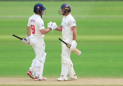 220626 - Glamorgan v Surrey, Rothesay County Championship Division 1- Colin Ingram of Glamorgan is congratulated win his 50 by Sean Dickson of Glamorgan
