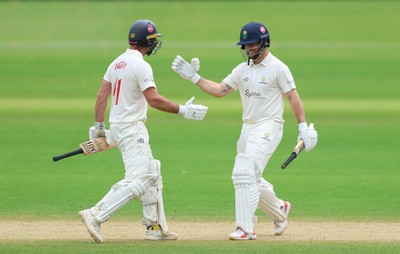 220626 - Glamorgan v Surrey, Rothesay County Championship Division 1- Sean Dickson of Glamorgan and Colin Ingram of Glamorgan celebrate the win over Surrey