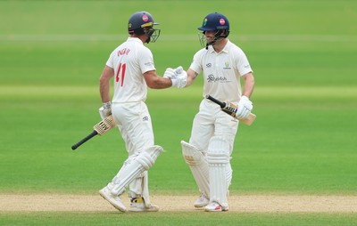 220626 - Glamorgan v Surrey, Rothesay County Championship Division 1- Sean Dickson of Glamorgan and Colin Ingram of Glamorgan celebrate the win over Surrey