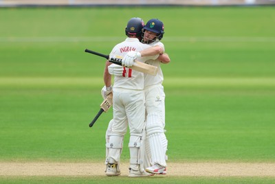 220626 - Glamorgan v Surrey, Rothesay County Championship Division 1- Sean Dickson of Glamorgan and Colin Ingram of Glamorgan celebrate the win over Surrey