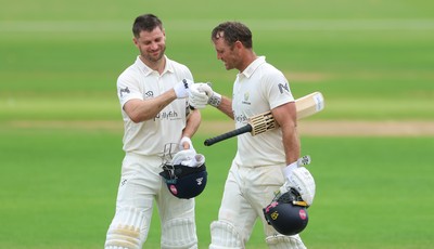 220626 - Glamorgan v Surrey, Rothesay County Championship Division 1- Sean Dickson of Glamorgan and Colin Ingram of Glamorgan celebrate the win over Surrey