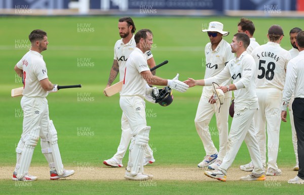 220626 - Glamorgan v Surrey, Rothesay County Championship Division 1- Sean Dickson of Glamorgan and Colin Ingram of Glamorgan shake hands with the Surrey players at the end of the match