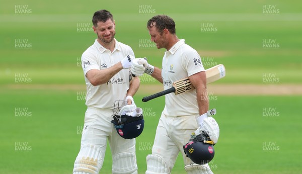 220626 - Glamorgan v Surrey, Rothesay County Championship Division 1- Sean Dickson of Glamorgan and Colin Ingram of Glamorgan celebrate the win over Surrey