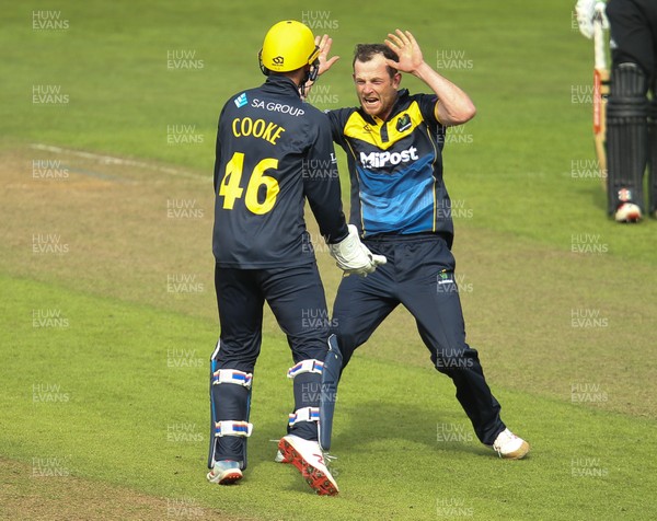 280419 - Glamorgan v Surrey, Royal London One Day Cup - Graham Wagg of Glamorgan celebrates with Chris Cooke of Glamorgan after taking the wicket of Jamie Smith of Surrey