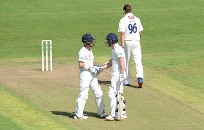 230816 - Glamorgan v Sussex - Specsavers County Championship -Graham Wagg of Glamorgan celebrates his half century with Mark Wallace (left)