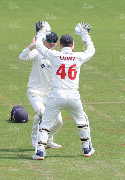 250623 - Glamorgan v Sussex, LV= Insurance County Championship, Div 2 - Tom Bevan of Glamorgan is congratulated by Chris Cooke of Glamorgan after catching James Coles of Sussex