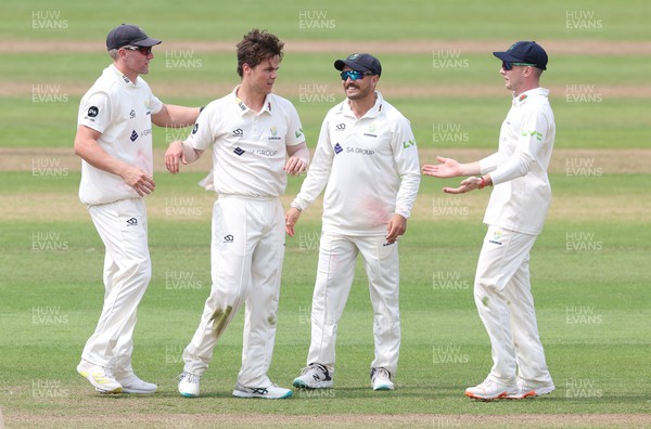 250623 - Glamorgan v Sussex, LV= Insurance County Championship, Div 2 - Mitchell Swepson of Glamorgan is congratulated after he takes the wicket of Nathan McAndrew of Sussex