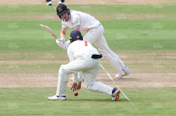 250623 - Glamorgan v Sussex, LV= Insurance County Championship, Div 2 - Jack Carson of Sussex plays a shot through the legs of Billy Root of Glamorgan