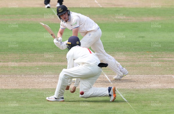 250623 - Glamorgan v Sussex, LV= Insurance County Championship, Div 2 - Jack Carson of Sussex plays a shot through the legs of Billy Root of Glamorgan