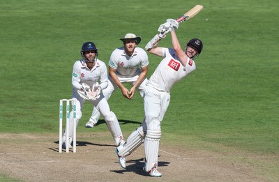 260816 - Glamorgan v Sussex, Specsavers County Championship, Division 2 - Luke Wells of Sussex hits a four as Mark Wallace of Glamorgan and Will Bragg of Glamorgan look on